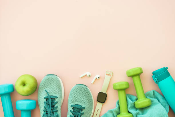 istock Fitness equipment on pink background, flat lay image. 1989919465