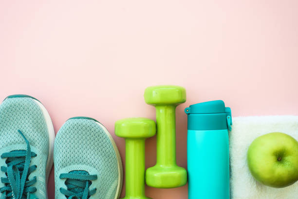 istock Fitness equipment on pink background, flat lay image. 1989919780