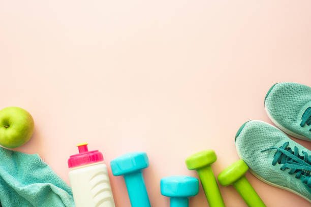 istock Fitness equipment on pink background, flat lay image. 1989920938