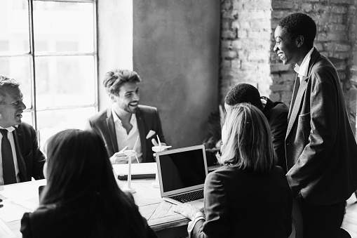 Multiracial business people working on sustainable innovation project - Green renewable energy concept - Focus on african woman face - Black and white editing