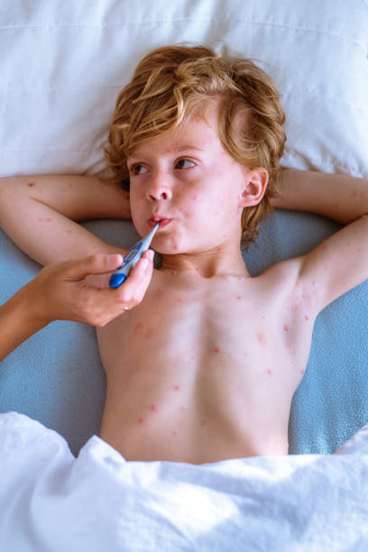 istock Crop mother measuring temperature of son 1989970556