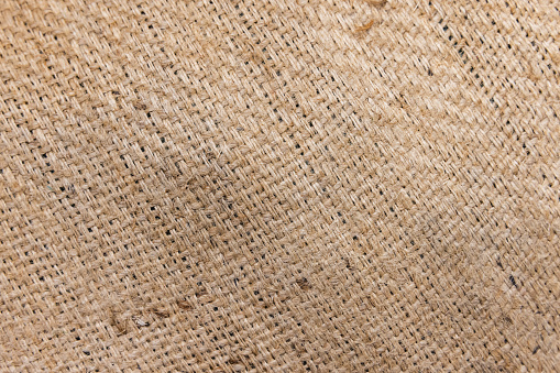 A bag for green coffee beans transportation made of natural Jute fabric. Background photo texture