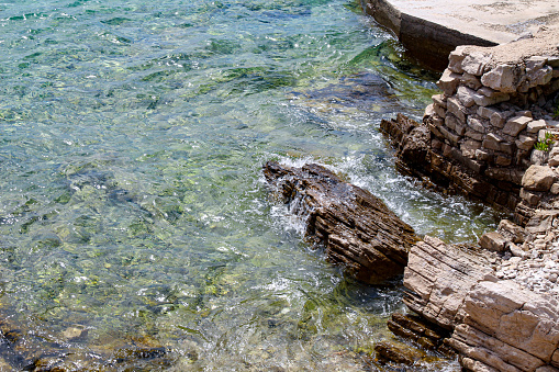 Blue Mediterranean Sea. Clear Water. Stones at the Bottom of the Mediterranean Sea. Small Waves.