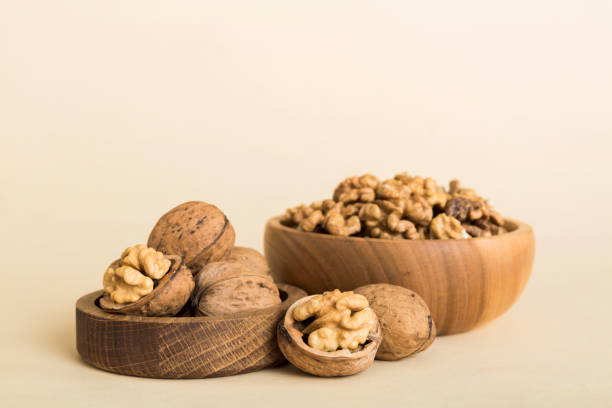 istock Fresh healthy walnuts in bowl on colored table background. Top view Healthy eating bertholletia concept. Super foods 1989981886