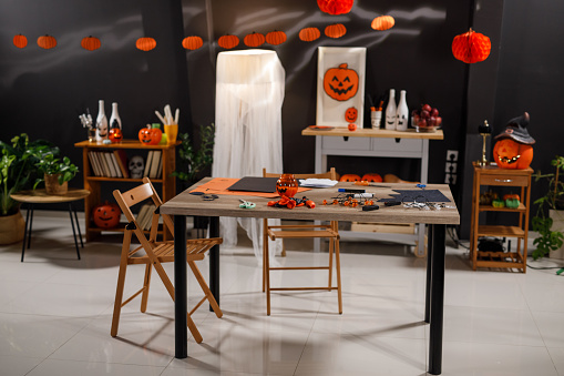 Copy space shot of a spooky dining room decorated for a Halloween party.
