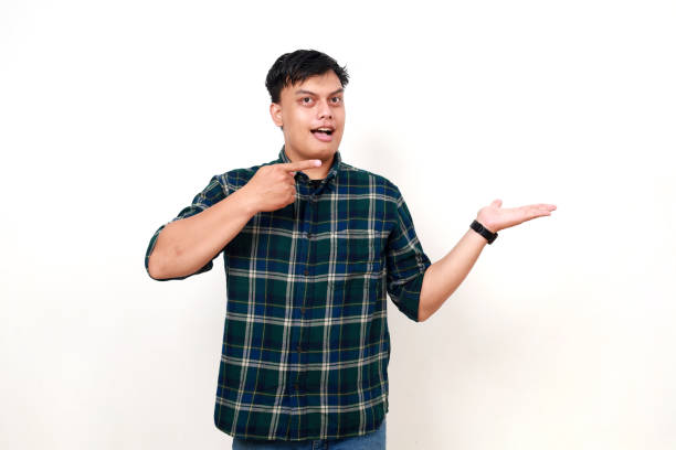 istock Young asian boy standing while presenting something on his hand. Isolated on white 1990002038