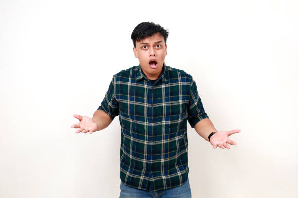 istock Young handsome asian man standing with confused gesture and face expression 1990005931