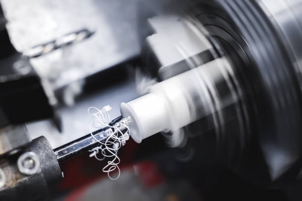istock Operation of a CNC lathe on a workpiece made of textolite or polyethylene or propylene. Automation of the production base. The chips are flying. 1990009746