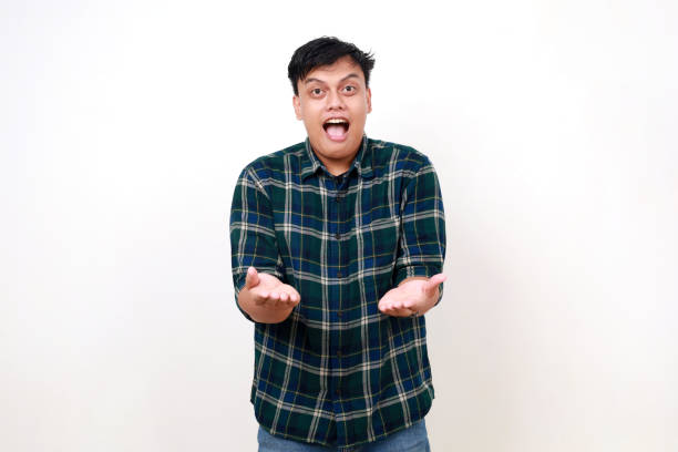 istock Wow excited young asian man holding something on his hands with surprised face expression 1990012997