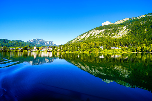 Landscape at Lake Altaussee in the Salzkammergut in Austria. Idyllic nature by the lake in Styria. Altaussee at Totes Gebirge with a view of the surrounding mountains.