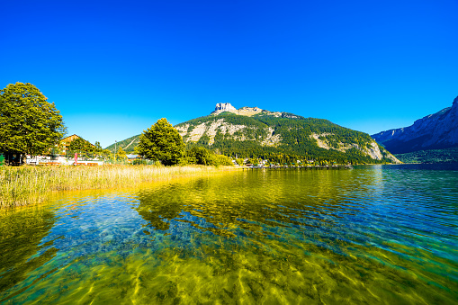 Landscape at Lake Altaussee in the Salzkammergut in Austria. Idyllic nature by the lake in Styria. Altaussee at Totes Gebirge with a view of the surrounding mountains.