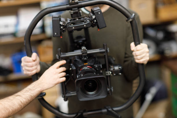 istock Professional videographer holding camera on gimbal rig steadycam to make video without shaking. 1990057817