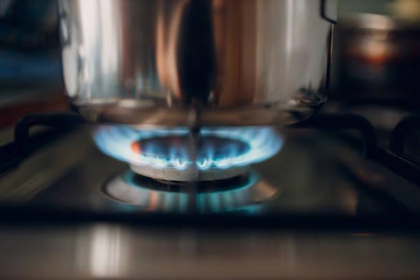 istock Burning gas flame on a kitchen gas stove pan. 1990057879