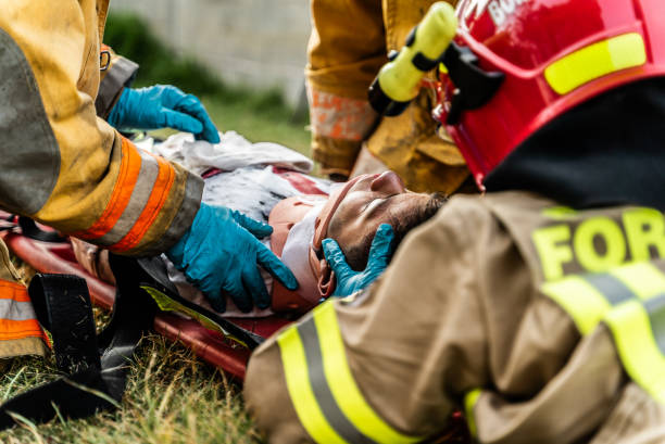 istock Firefighters putting a neck brace on a accident victim 1990058367