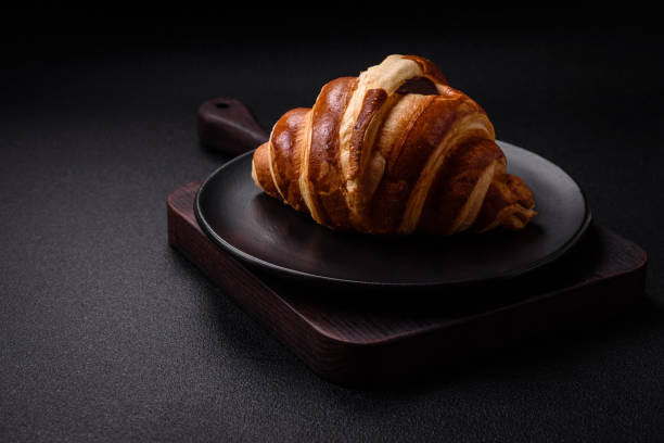 istock Delicious crispy sweet croissant cornet with chocolate 1990063552
