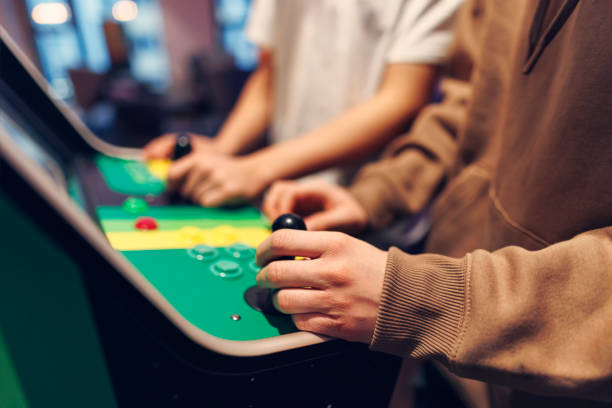Closeup of teenagers playing retro arcade video game Closeup of teenagers playing retro arcade video game
Shot with Canon R5 arcade stock pictures, royalty-free photos & images