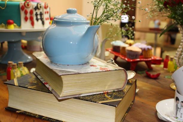 Fantasy themed birthday table decoration. Teapot and books.