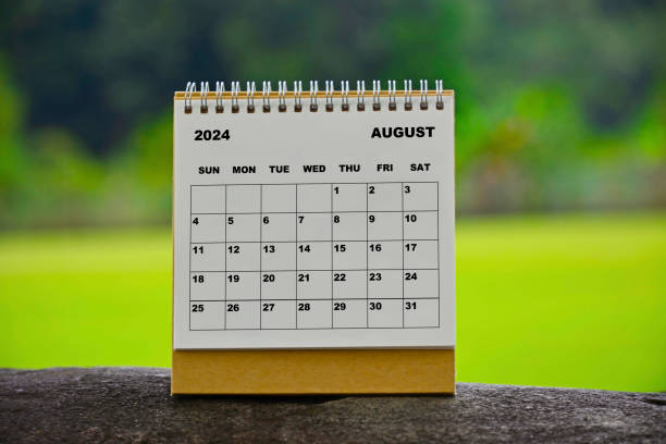 istock August 2024 white calendar with green blurred background. 1990126075