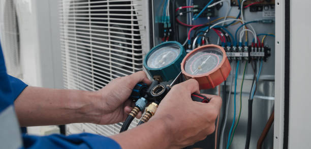 istock Technician is checking air conditioner,measuring equipment for filling air conditioners. 1990126836