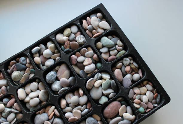 Cellular Cassette Filled With Clean Colored Pebbles On White