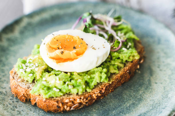 istock Healthy homemade rustic breakfast Toast With Avocado and Boiled Egg. 1990163120