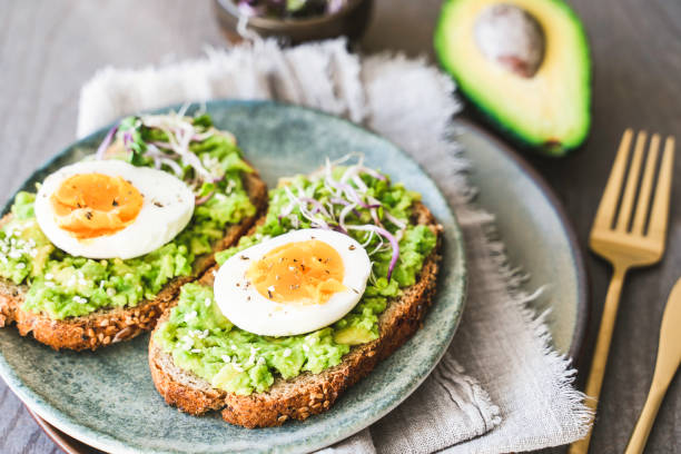 istock Healthy homemade rustic breakfast Toast With Avocado and Boiled Egg. 1990163123