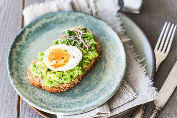 istock Healthy homemade rustic breakfast Toast With Avocado and Boiled Egg. 1990163124