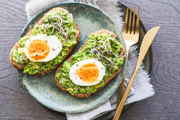 istock Healthy homemade rustic breakfast Toast With Avocado and Boiled Egg. 1990163127