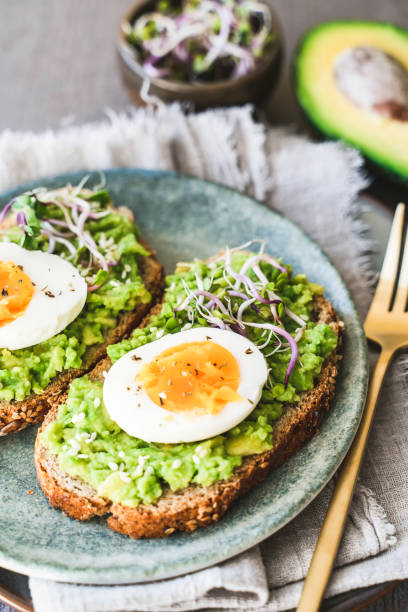 istock Healthy homemade rustic breakfast Toast With Avocado and Boiled Egg. 1990163131