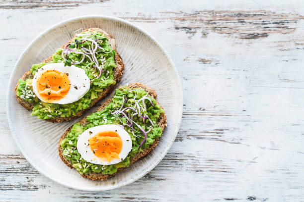 istock Healthy homemade rustic breakfast Toast With Avocado and Boiled Egg. 1990163132
