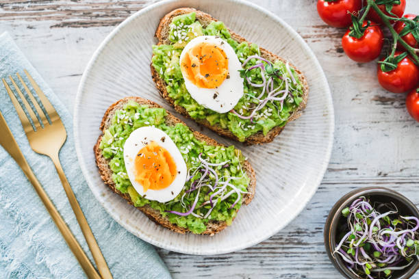 istock Healthy homemade rustic breakfast Toast With Avocado and Boiled Egg. 1990163134