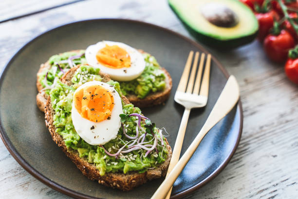 istock Healthy homemade rustic breakfast Toast With Avocado and Boiled Egg. 1990163138