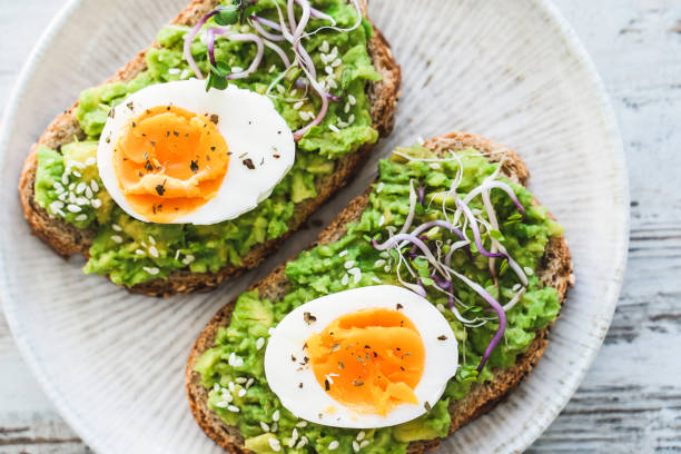 istock Healthy homemade rustic breakfast Toast With Avocado and Boiled Egg. 1990163140