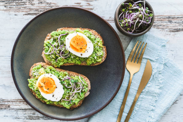 istock Healthy homemade rustic breakfast Toast With Avocado and Boiled Egg. 1990163141