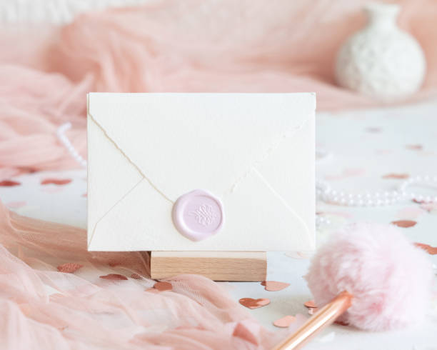 istock Sealed envelope near pink decorations, hearts and tulle on white table close up, mockup 1990166298