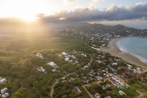 San Juan Del Sur beach shore aerial drone view in sunrise light