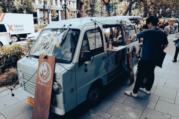 Tokyo, Japan, May 6th, Man buying coffee at a street stall in Tokyo