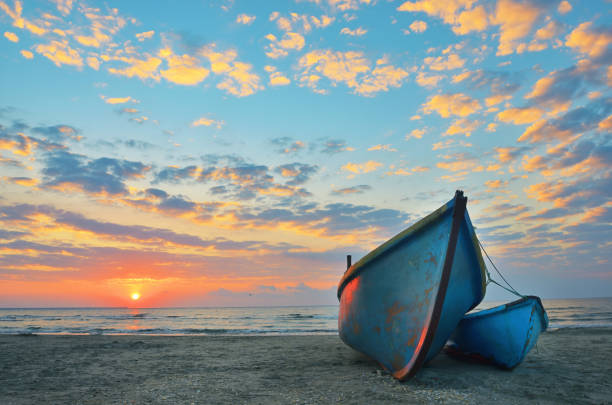 Sunrise at Black Sea over an old fishing boats stock photo