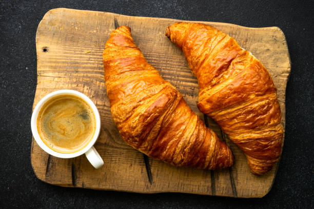 istock Croissant at black background top view. 1990222960