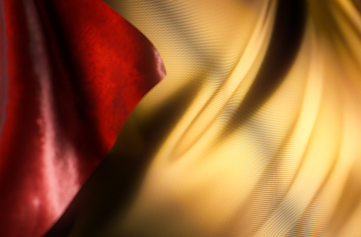 Elegant background with a gold red fabric with ripples from the wind. Part of a series digitally created 3D images with a Christmas advent calendar theme.