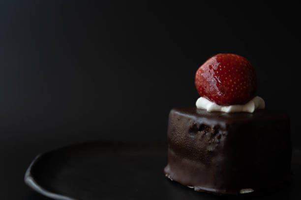 Chocolate cake topped with Fresh Strawberry on Red background