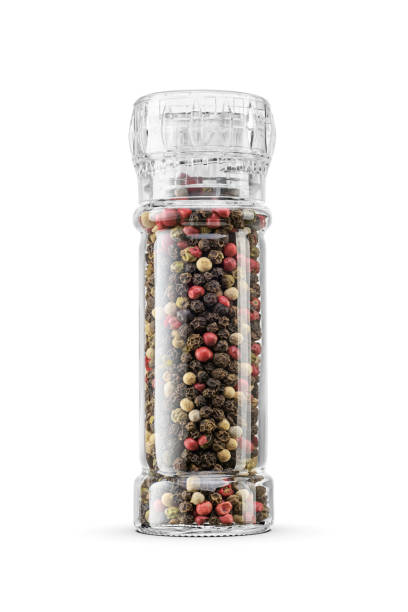 istock Pepper grinder. Mix of different types peppercorns in transparent mill isolated on a white. 1990228423