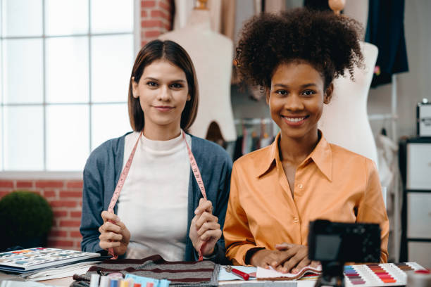 istock two women designer discusses and exchange ideas for clothing design with intention and happiness. 1990246438