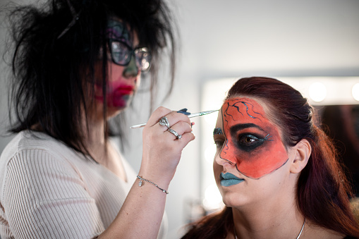 Two woman preparing for Halloween party