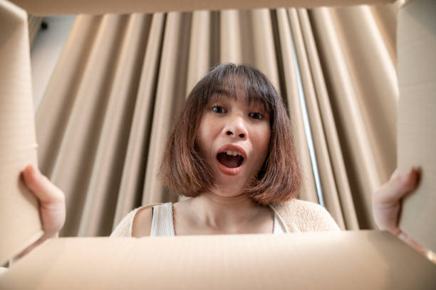 istock Excited young woman with items she ordered 1990252808