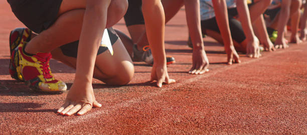 istock Cropped image of a sprinter getting ready to start at the stadium 1990255456