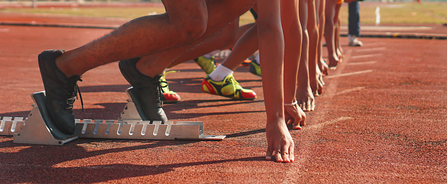 close up of runners feet on the track field