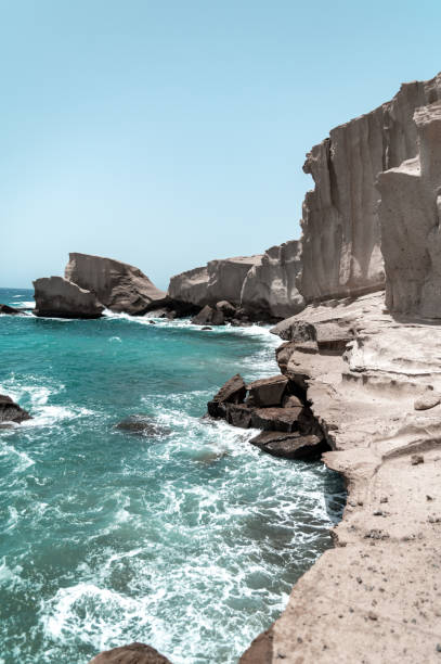 istock rocks cliff in the turquoise sea 1990298027