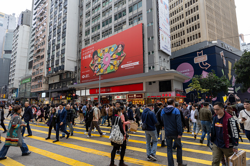 Hong Kong - February 6, 2024 : Pedestrians walk past the Hennessy Road in Causeway Bay, Hong Kong.