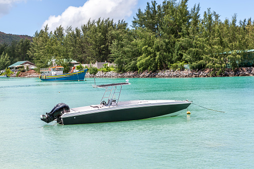 speedboat mooring at beautiful lagoon at praslin island, seychelles islands, indian ocean islands.